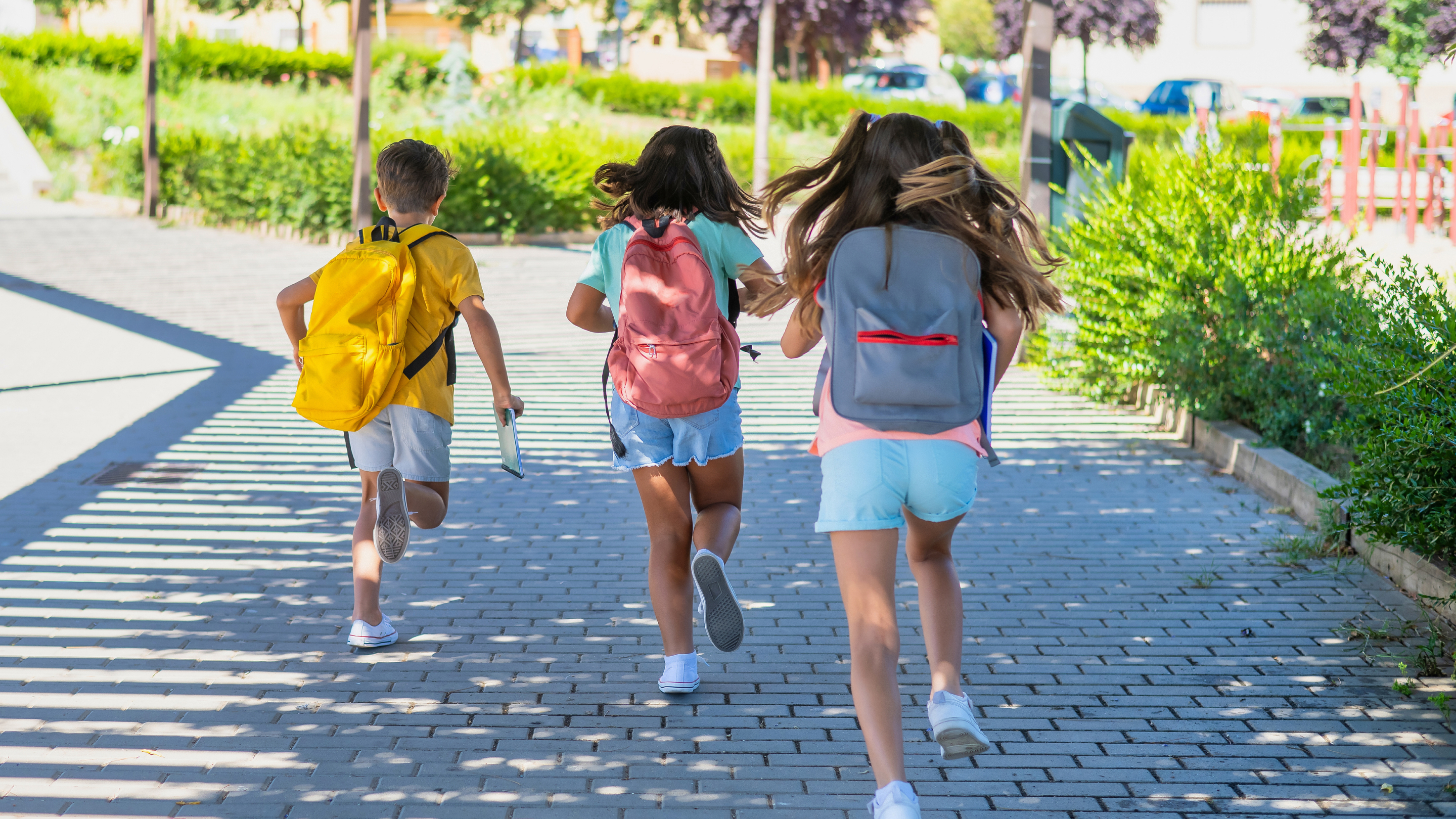 Laufende Kinder mit Rucksack